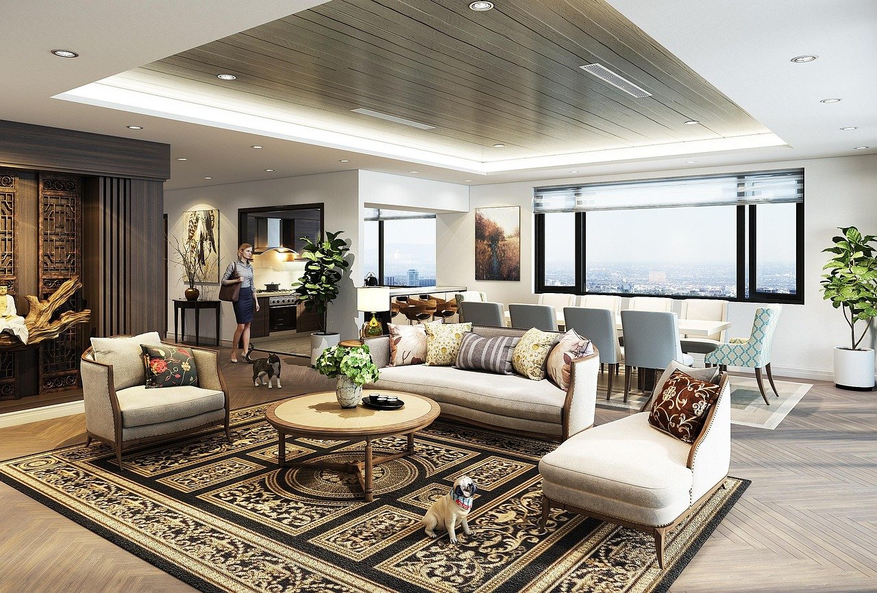 sala de convivencia con espacios amplios, sillones en tonos blancos y tapetecafé